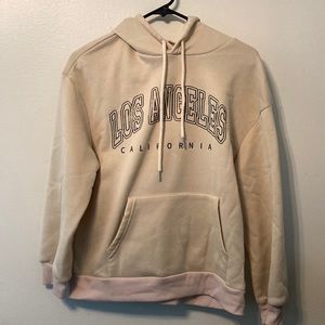 From Shein, Medium, is a Tan color with Black writing